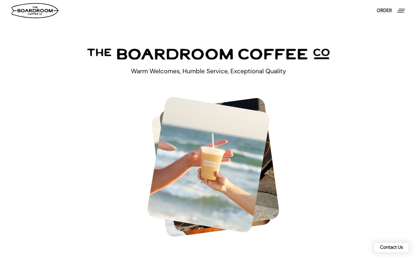 The Boardroom Coffee Co. home page: the wordmark above a photo of an iced coffee handed across at the beach